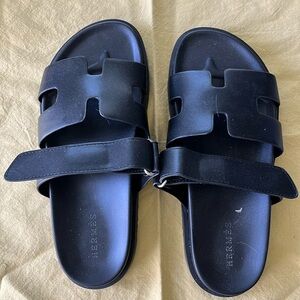 New. Never worn. Black slides by Hermes